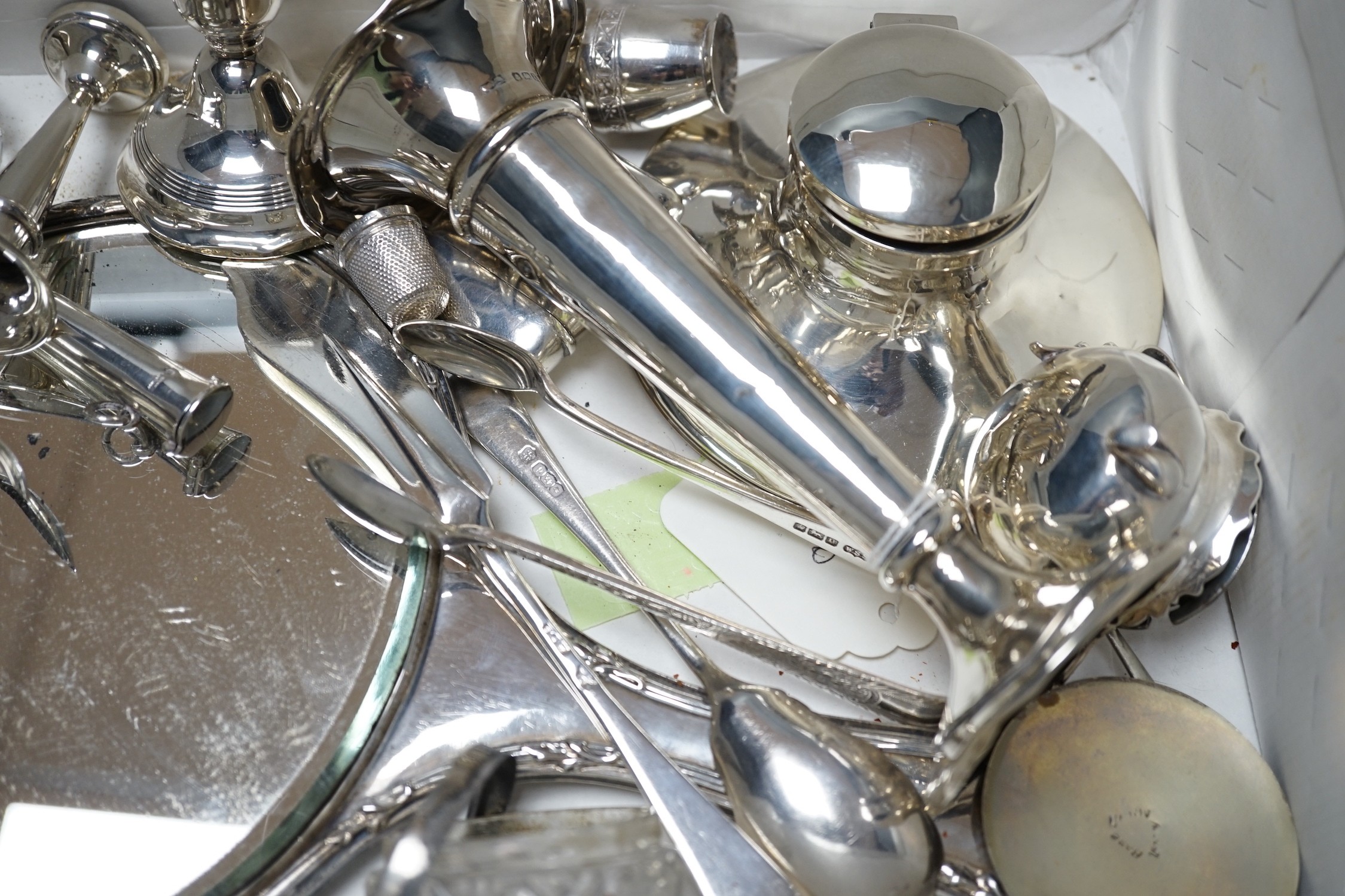 Sundry small silver items including a hand mirror, capstan inkwell, flatware, vesta case, mounted glass salts, dwarf candlesticks, condiments, posy vase, etc.